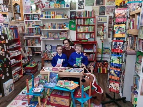 Jenni Doherty, Little Acorns Bookstore with St Paul's Primary School, Slievemore Year 7 pupils Clara O'Hagan and Tiernan McGrory.