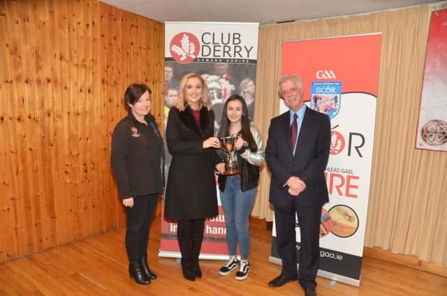 Doire Trasna's Eva Cassidy receives the Niamh McGlinchey Cup for Solo Singing from former All Ireland Senior Solo Singing Champion  Hannagh Ferguson at Glenullin last week. Included on left is Ãšna Ferguson, Coiste ScÃ³r Dhoire  and MicheÃ¡l Ahern from Club Derry.