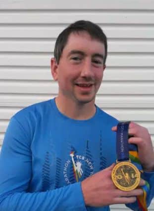 Ryan McCaul outside his home after he'd completed the New York marathon in 2014. PHOTO by Derry Journal