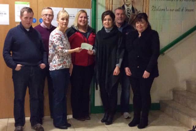 Darren Mullan, Seamus Mullan, Margaret Mullan, Catherine McLaughlin and Noel McFeely, some of the committee involved in organising the night presenting the cheque to Margaret O'Connor and Ann Marie Convery from Glenshane Care Centre. The proceeds were raised from a charity night held by O'Brien's GAC