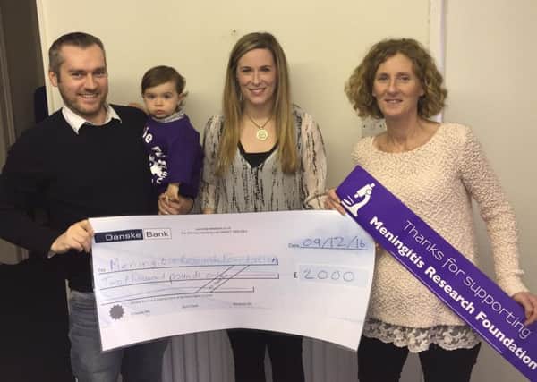 Maria and Vincent Bradley and their son Padraig present a cheque to the Meningitis Research Foundation