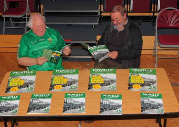 Moville St Patrick's Day committee  chairman Eamonn McLaughlin and secretary Gerard Sona reading over the book at its launch in St. Eugene's Hall, Moville.