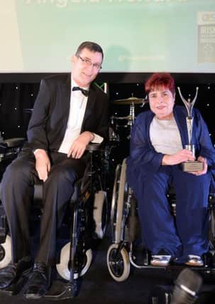 Angela Hendra, MBE being presented The Irish Paralympic Order by Jimmy Gradwell, President of Paralympics Ireland.