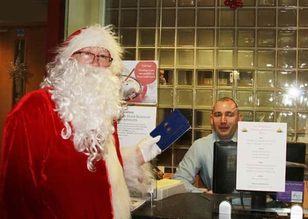 Santa Claus pictured visiting the Derry Santander branch in the Diamond on Wednesday.