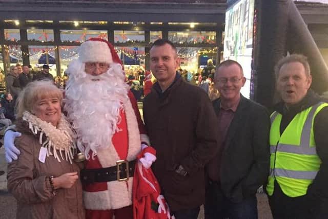 Santa drops in at Brooke Park joining Maeve McLaughlin, Colrs. Mickey Cooper and Eric McGinley and Billy Page.