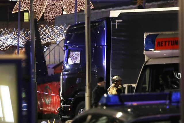 Police stand beside the damaged truck in Berlin.