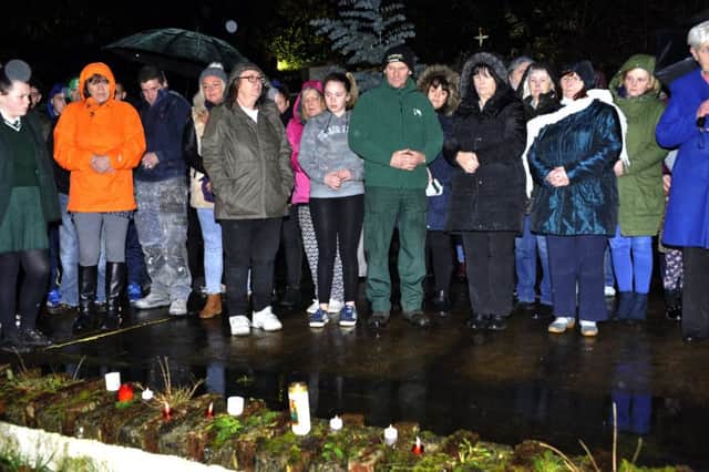 Relatives of children and young people from the area who passed away pray in silence at the Brandywell Grotto during a candlelight tree planting ceremony in their memory. DER5116GS020