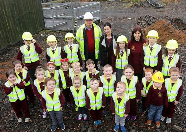 Pupils celebrate phase three of the Gaelscoil with principal Chairmaine Deery, Frank McGurk of JDC Joinery and Builders. 45151KDR