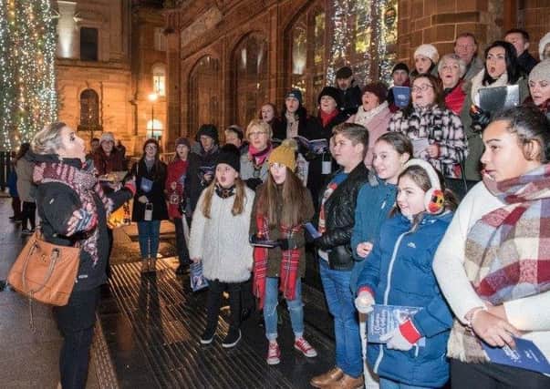 In fine voice.... choristers raising their voices on the steps of the Guildhall at the Mayor's Christmas Choral Gathering.