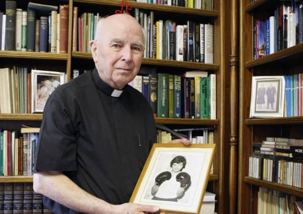 Bishop Edward Daly holds a portrait of Jackie Duddy (Niall Carson/PA Wire)