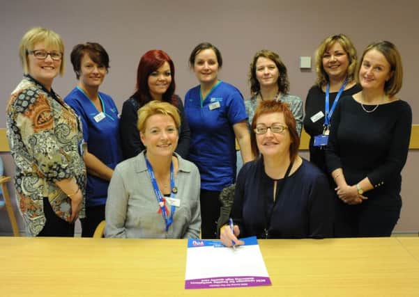 Western Trust Midwifery staff signing the RCM Staff Wellbeing Charter seated are Deirdre Gill, Clinical Risk Midwife and Maureen Miller, Acting Head of Midwifery and Gynae Services, Western Trust along with midwifery staff standing from left to right: Amanda Sayers, Community Lead Midwife; Sharon Woods; Sinead Lecky; Ashley Smyth; Brenda McClafferty; Aine McDermott and Beverley Crothers.