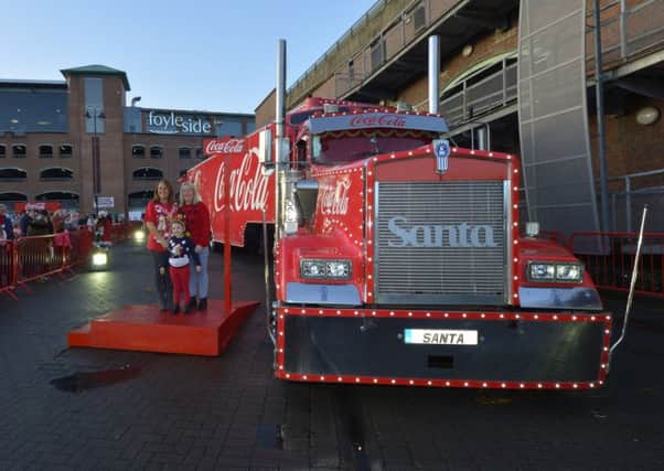 Sandra Carlin, Patrica Harkin and Rileigh Harkin (5) pose for photographs beside the Coca Cola truck during its recent visit to Foyleside. DER5016GS026