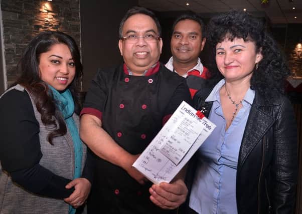 Hot Tip...The Indian Tree Restaurant staff pictured with the receipt for a tip of Â£1,000 from a generous customer. Included are from left, Luna Ekush, director, Babu, chef, Martinho Silva, tandoori chef, and Maria Bulcau, kitchen assistant. INPT02-206.