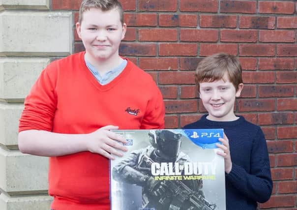 Niall Coll from Feeny handing over his PS4 bundle to TJ Watson.