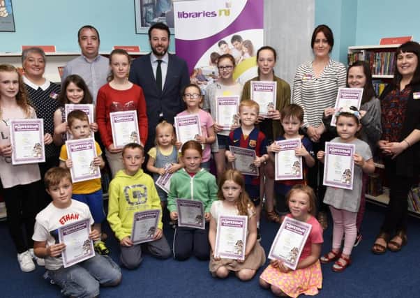 SDLP party leader Colm Eastwood MLA pictured with children who were presented with certificates after completing the Big Summer Read event at Shantallow Library. Included are Councillor Brian Tierney and library staff, from left, Marie-Elaine Tierney, Lorraine Coll and Emma Forbes. DER3516-101KM