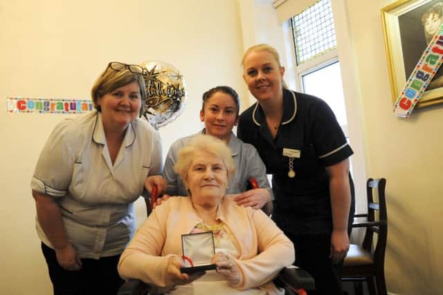 Pictured with Lily are members of staff from Brooklands Nursing Home, Derry.