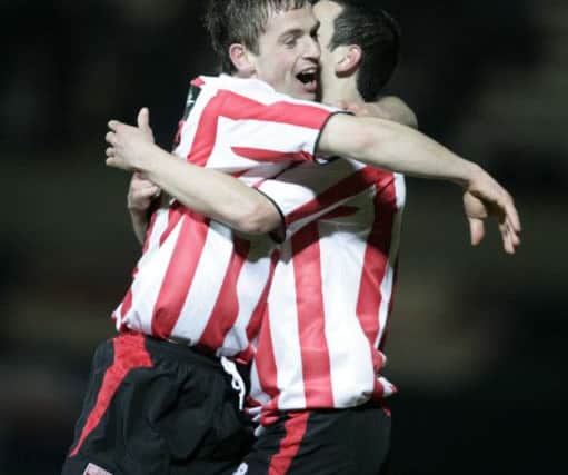 Mark Farren celebrates the opening goal for Derry against Linfield with Kevin McHugh.