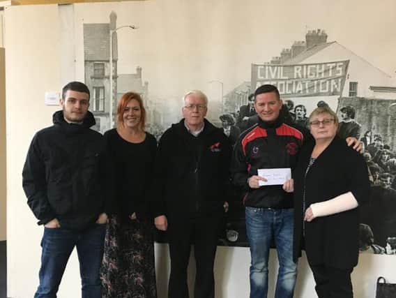 Sinn FÃ©in Councillor Colly Kelly handing over cheque for proceeds of Bloody Sunday Weekend fundraising efforts to Jean Hegarty, also in photo  John Kelly Bloody Sunday Trust , Rossa O'Dochartaigh, Julie Ann Campbell.The handover took place in the temporary Free Derry  Museum on Shipquay street