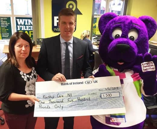 Jacqueline Williamson; Kinship Care NI being presented with a cheque by Colin Mullan from Derry based company  Find Insurance NI. Also pictured is Kuddles the Kinship Care Bear. Kinship Care was the the Find Insurance NI Charity of the Year for 2016.