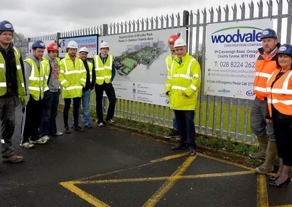 Derry City and Strabane District Council Job Brokerage Officer Mena Kearney pictured with representatives from Woodvale Construction and construction workers who gained jobs and apprenticeships with the firm as part of the contract for the multi-million pound redevelopment of Brooke Park.