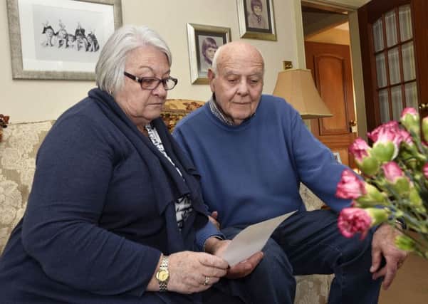 Jack and Violet Glenn pictured reading one of the many sympathy cards they have received after their grandson, Jack, had entered the River Foyle twelve days ago.