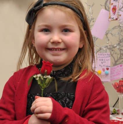 Five year-old Myleigh Houston pictured with her Valentines Day rose at the Farland Way community centres  Valentines Day childrens party. DER0717GS004