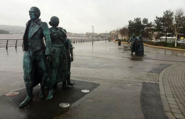 Derry artist, Ã‰amonn O'Doherty's 'The Emigrants' sculpture along the quay.