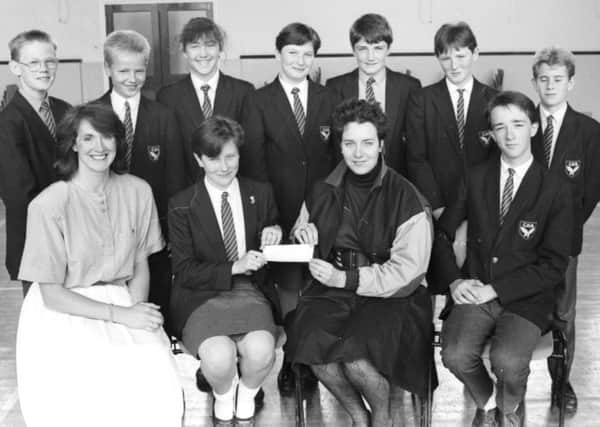 1989: Elaine Colhoun, seated second from left, presents a cheque on behalf of second year pupils at Clondermot High School to Mrs Lesley McAuley, NSPCC. Also seated are Avril Watt, teacher, and James Fielding. At back are James Connor, Robert Finlay, Carol Walker, Lesley Cowan, Gary Duddy, Anne Henderson and Keith Heaney.