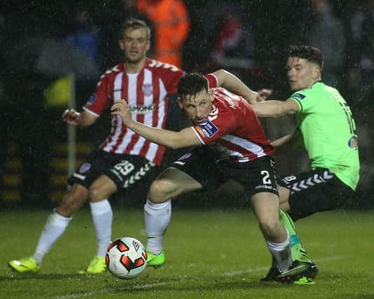 Derry City's Conor McDermott tussles to get away from Limerick's Dean Clarke. Picture by Lorcan Doherty/Presseye
