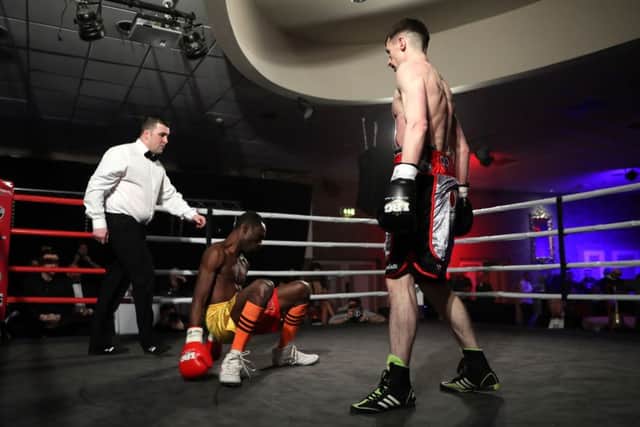 Tyrone McCullagh stands over Michael Barner after landing a flurry of punches in the second round.