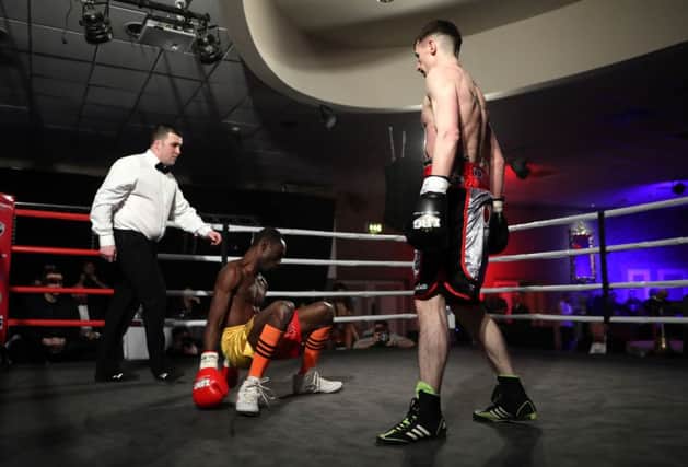 Tyrone McCullagh stands over Michael Barner after landing a flurry of punches in the second round.