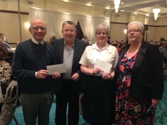 President Mary McCloskey and Past President Brian McMurray presenting cheques to Jim Herron of the St Vincent de Paul and Major Joan Archibald of the Salvation Army.