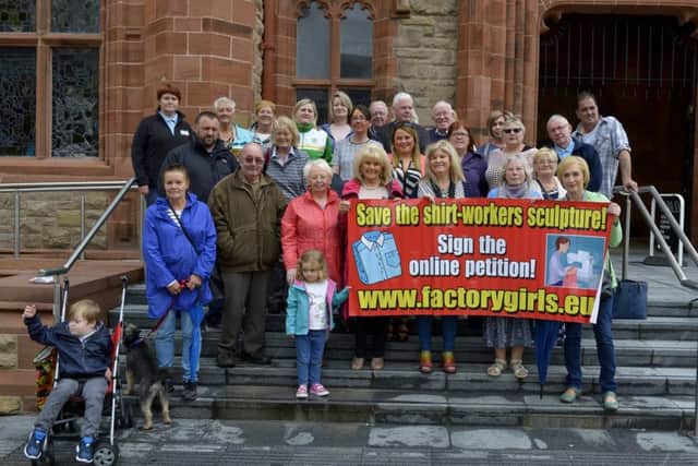 Protesters gathered in Guildhall Square last year highlighting concern over the continuing delay in the public artwork dedicated to thousands of Derry women who worked in factories. DER3016GS005