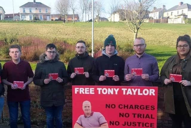 CaolÃ¡n Mac Fhionnghaile, chairpoerson, alongside other Sinn Fein youth members calling for Tony Taylor to be freed.