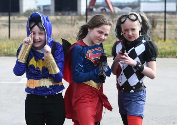 Bat girl , Super women  and Harley Quinn  at the Titanic exhibition centre on Sunday, with people dressed up as the favourite super heroes at the weekend. 
Pictures by Colm Lenaghan/Pacemaker Press