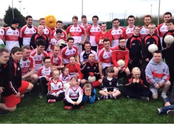 Members of the Derry senior panel, staff and players at an event to mark World Down's Syndrome Day at Owenbeg in 2015.