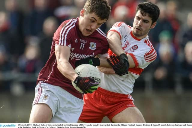 Michael Daly is hauled back by Niall Keenan in the incident that led to one of Galway's penalties at St. Jarlaths Park in Tuam.