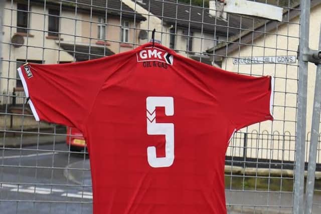 Derry no46-20/3/2017-Trevor McBride pictureÂ©a Derry City FC shirt with number5 on the back-the number worn by Ryan McBride,the Derry City FC captain who has died-placed along the surrounding fencing at the Brandywell Showgrounds(Derry Citys home ground-undergoing major redevelopments at present)Note-( Bluebell Park where he lived is directly opposite -see street name through mesh)