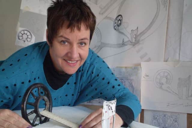 Artist Louise Walsh with some of her designs for the sculpture.