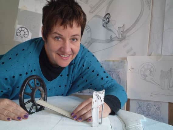 Artist Louise Walsh with some of her designs for the sculpture.