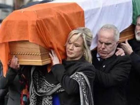 Michelle O'Neill, Raymond McCartney and Gerry Adams carry the coffin of Martin McGuinness