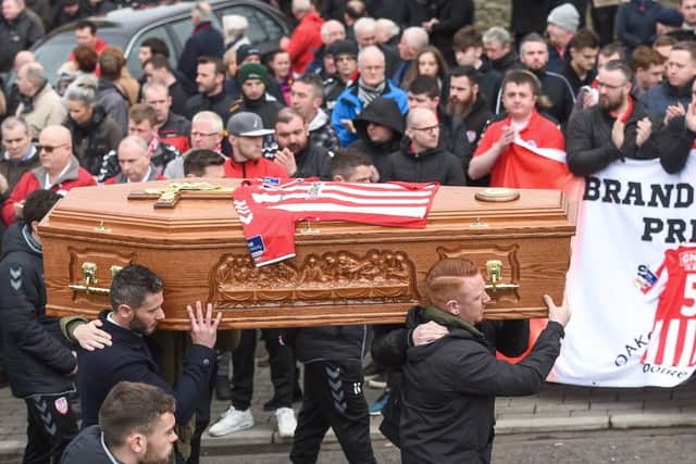 Derry City players carry the coffin from the chapel at the funeral of Ryan McBride, the late Derry City captain who passed away suddenly at the age of 27.