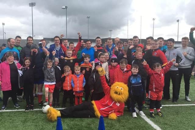 Derry's senior footballers with participants of the GAA for All event at Owenbeg on Saturday. The event was also held to mark World Down Syndrome Day which fell on Tuesday 21st March.