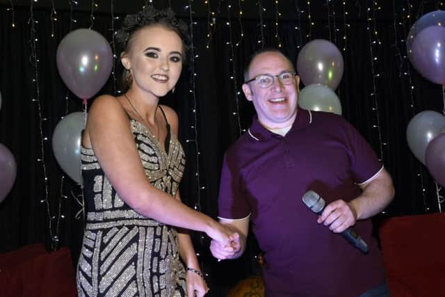 Cancer sufferer Alexandra Johnston is greeted by Fr. Chris Ferguson, the host for the evening, when she arrived at her suprise 'Evening with Alexandra' event held in the Gasyard Centre by the Pink Ladies and the Gasyard Development Trust. DER1317-105KM
