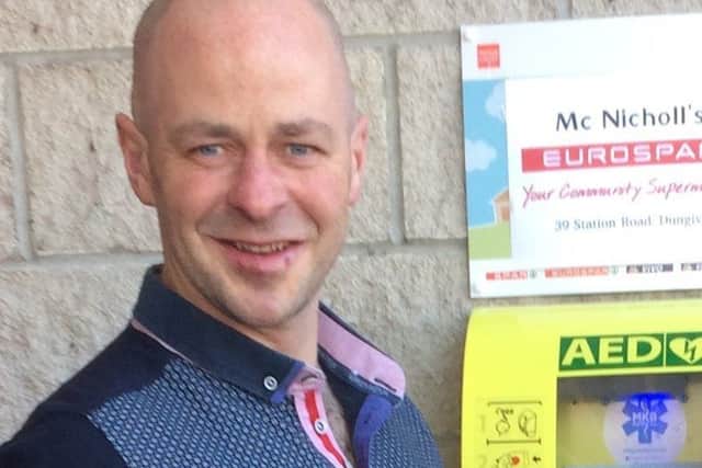 Kevin McCloy beside the new defibrillator at Eurospar in Dungiven