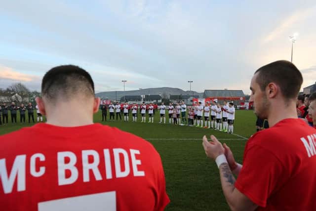 Derry City players during the minutes applause.