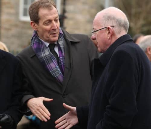 Irish foreign minister Charlie Flanagan shakes hands with Alastair Campbell as they arrive for the funeral of Martin McGuinness.