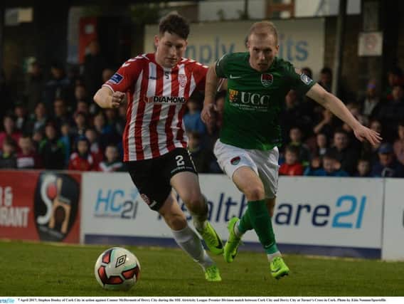 Man of the match, ex Derry winger, Stephen Dooley skips past the challenge of Conor McDermott.