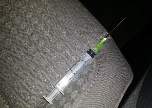 The syringe and needle left in the back seat of the taxi driver's car on Holy Thursday.