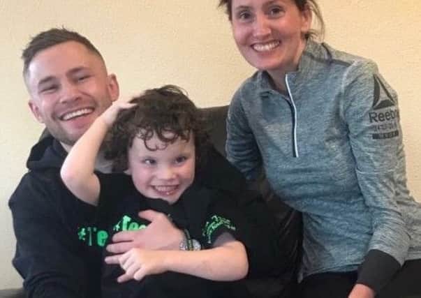 Carl Frampton pictured with little four year-old, Rory Gallagher and Rory's mum, Shauna.